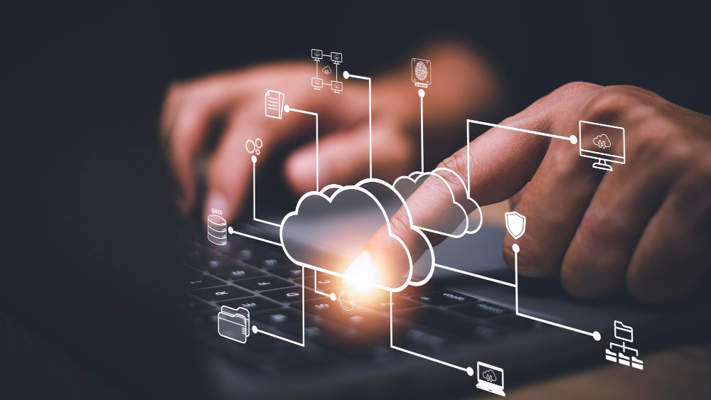 Cloud computing diagram overlaid on laptop typing to represent Boomi aXis connector for SAP